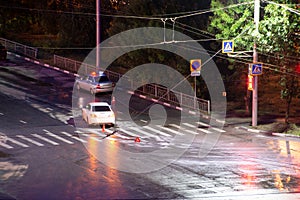 At the crossroads at night, the driver violated and knock down a pedestrian. The police draw up a road traffic accident. Police
