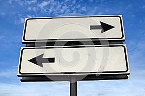 Crossroads Road Sign, Two Arrow on blue sky background