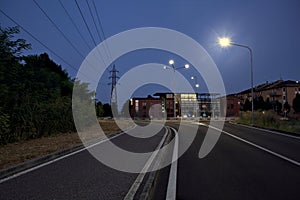 Crossroads with street lamps in a village in the italian countryside at night