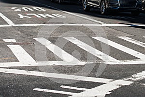 Crosswalk in the city street intersection asphalt road with marking lines and signs