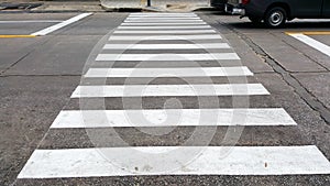 Crosswalk on the road for safety when the car has passed the white crosswalk sign in the morning