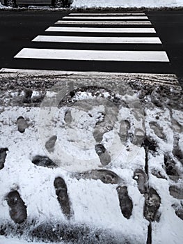 Crosswalk slush. Pedestrian crossing in winter.