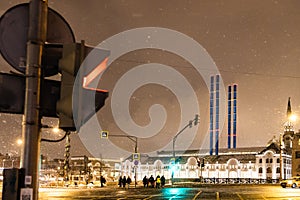 crosswalk in snowfall in Moscow city in evening