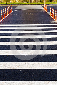Crosswalk surface background,top view. pedestrian crossing, white stripes on black asphalt, traffic rules