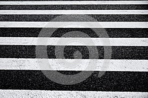 Crosswalk surface background,top view. pedestrian crossing, white stripes on black asphalt, zebra crossing