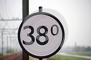 Crossway sign at a railroad track in the Netherlands, when trains is passing this sign, at 38Km the crossway will be closed.