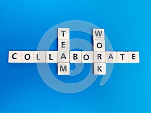 Crosswords collaborate teamwork made from square letter tiles.