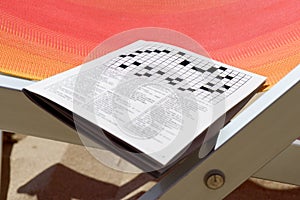 Crosswords on the sand deckchair