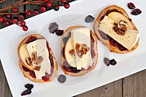 Crostini with cranberry sauce, apples, brie and pecans, above view