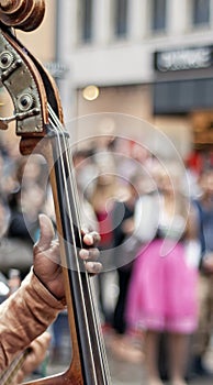 Croud of people hearing a Cello player photo