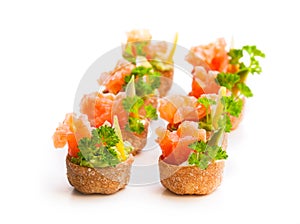 Croustades crispy pastry cases filled with salted salmon and av