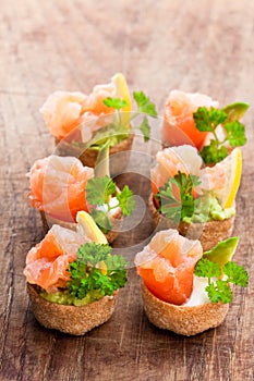 Croustades crispy pastry cases filled with salted salmon and av