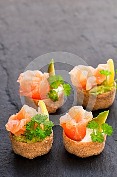Croustades crispy pastry cases filled with salted salmon and av