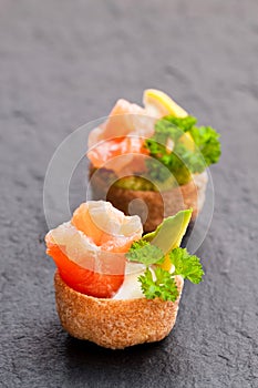 Croustades crispy pastry cases filled with salted salmon and av