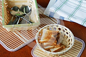 Croutons in a basket and cutlery