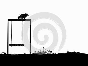 crow perched on a child\'s swing