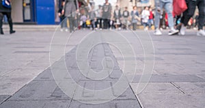 Crowd of anonymous people walking on busy city street