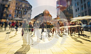 Crowd of anonymous people walking on busy city street