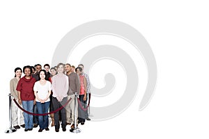 A crowd behind a barrier