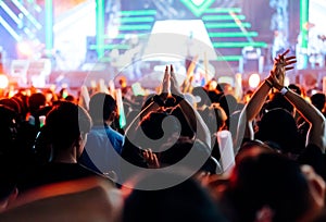 Crowd clap or hands up at concert stage lights photo