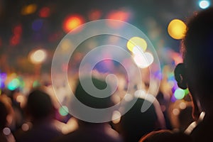 Crowd at a concert in front of bright stage lights with bokeh effect
