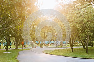 Crowd and diversity of people, men and women are running in the park with morning sunlight