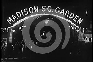 Crowd milling beneath neon Madison Square Garden marquee, 1930s