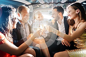 Crowd of party people in a limo with drinks