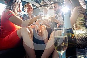 Crowd of party people in a limo with drinks