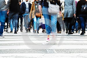 Crowd of people crossing a city street