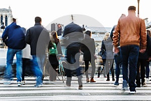 Crowd of people crossing a city street