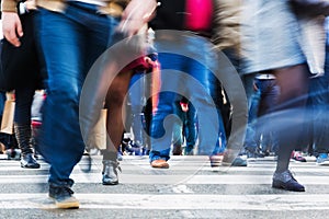 Crowd of people crossing a city street