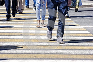 Crowd of people crossing a street in the city