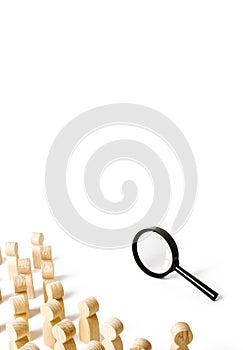 A crowd of people looking into a magnifying glass. Search and tracing concept, finding out the truth. Find a solution