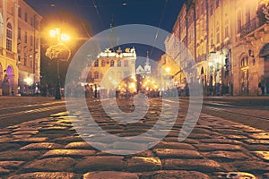 A crowd of people moving on the old European city night street