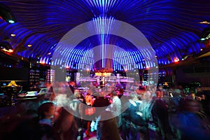 Crowd of people relaxing in bar photo