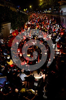 Crowd of people ride motorbike on street at night