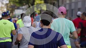 Crowd of people running marathon in city