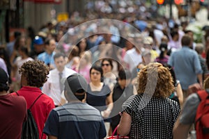 Crowd of people walking on street sidewalk