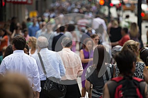 Crowd of people walking on street sidewalk