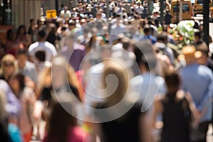 Crowd of people walking on street sidewalk