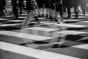 Crowd of people walking on zebra crossing street