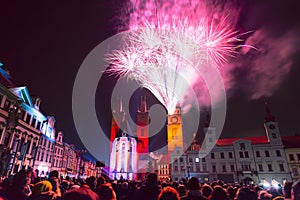 Crowd of people watching New Year fireworks in historic city center of Hradec Kralove, Czech Republic