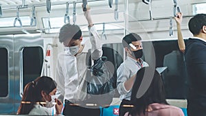 Crowd of people wearing face mask on a crowded public subway train travel