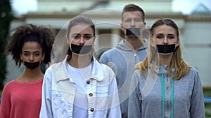 Crowd performance with taped mouth, violation of speech freedom, censorship