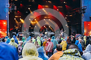 Crowd in raincoats during festival preformance