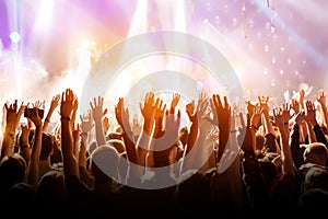 Crowd with raised hands on music concert