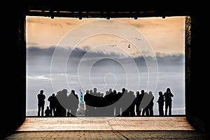 CROWD IN SILHOUETTE TOGETHER LOOKING AT STATUE OF LIBERTY NEW YORK