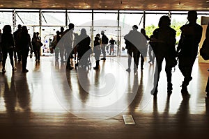 Crowd silhouettes at main entrance of convention center