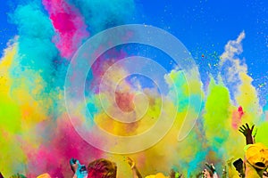 Crowd throws colored powder at holi festival